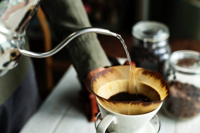 pouring hot water to a ground coffee