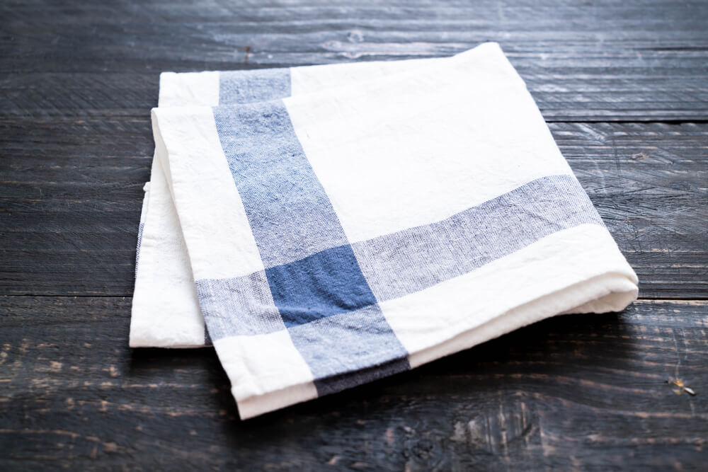 Kitchen napkin laid on top of a table