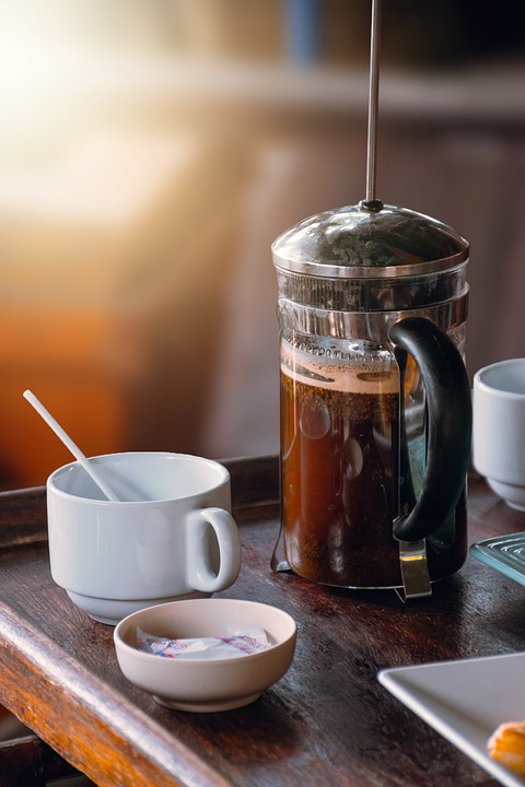 French press coffee at center of a wooden block