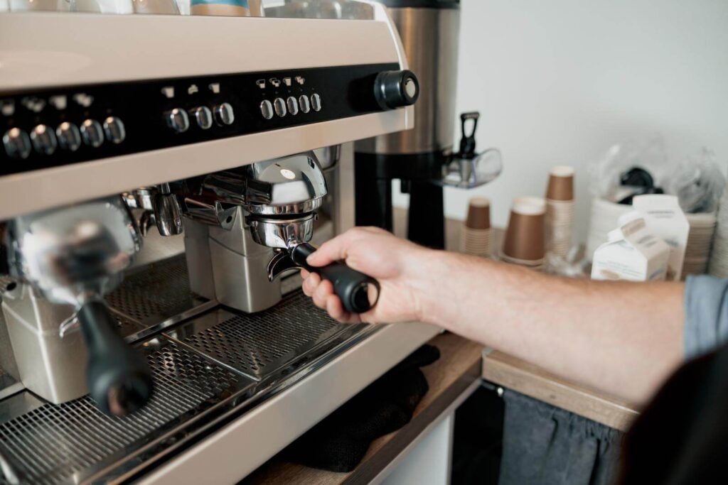 Male barista installing filter with pressed coffee into espresso machine can i use regular coffee in espresso machine