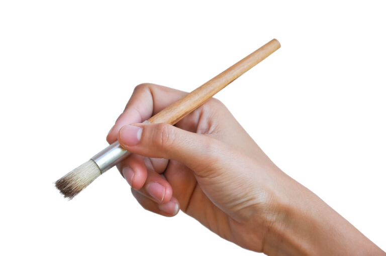 A hand held brush for cleaning a coffee grinder.