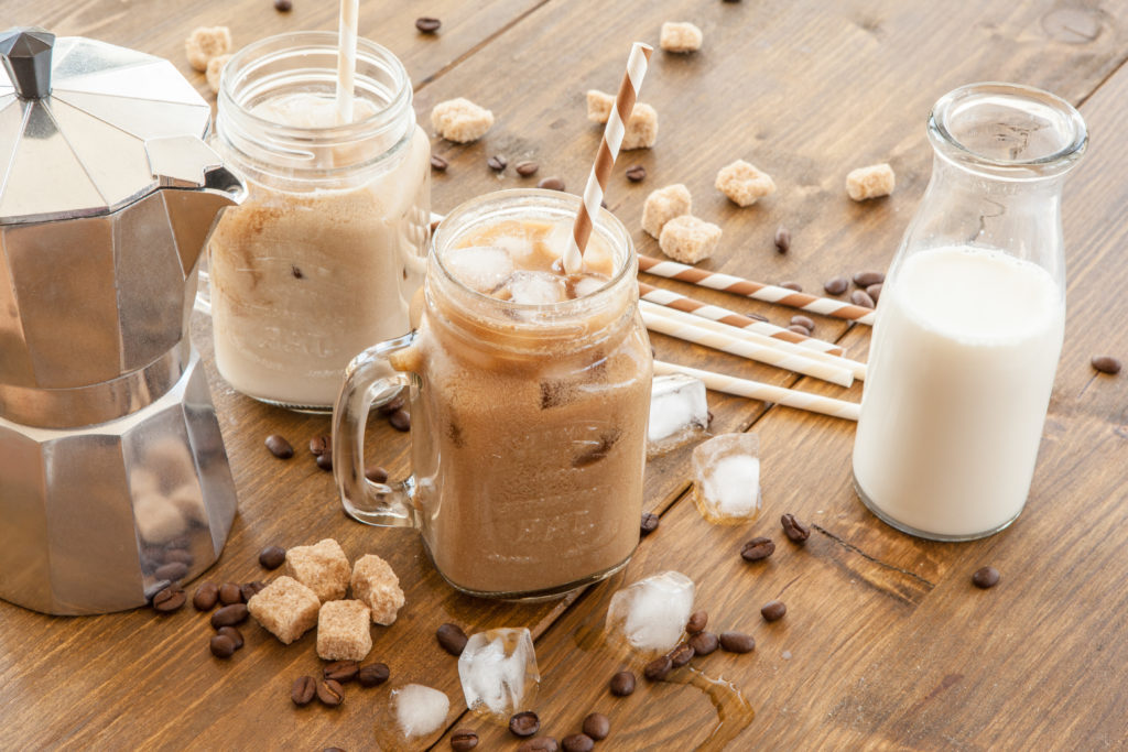 Several iced coffee with coffee beans and Moka pot