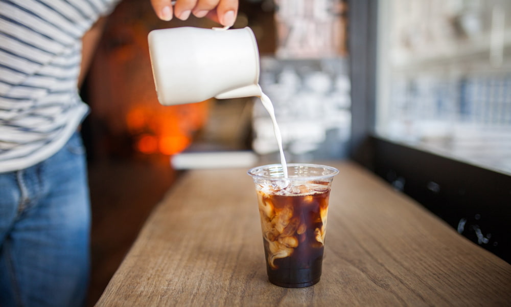 Pouring milk into cold brew