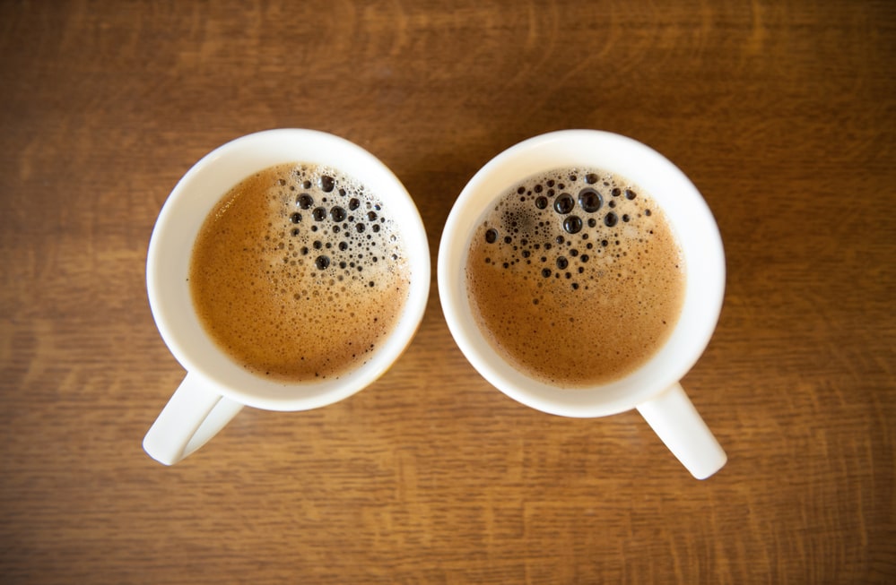 Two cups of espresso coffee on a table.