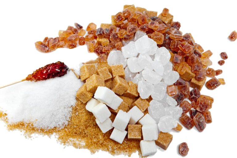 A piece of cake on a plate, with Sugar