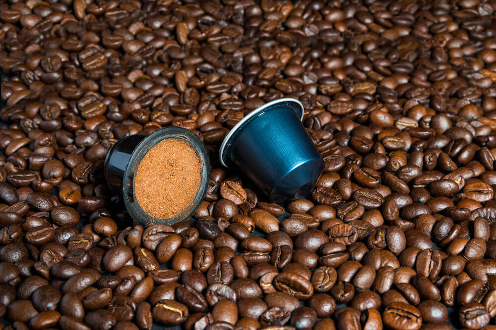 Hamilton Beach 49980A - coffee capsules and whole coffee beans in the background