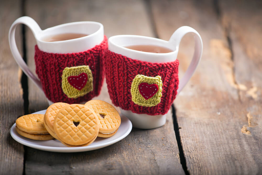 two cups of English tea with biscuits on a plate