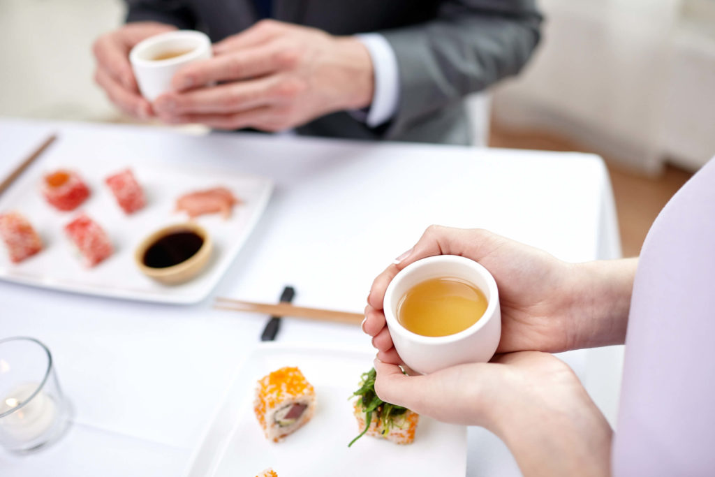 two people in tea room enjoying their cup of tea