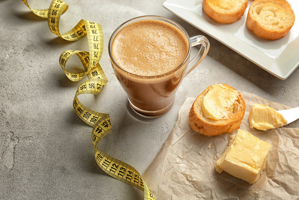 a cup of bulletproof coffee, a bread, a cheese