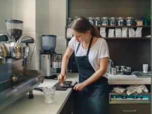 Woman grinding coffee beans