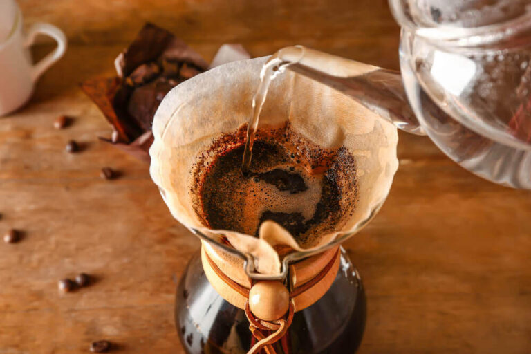 Preparing of tasty coffee in chemex on table