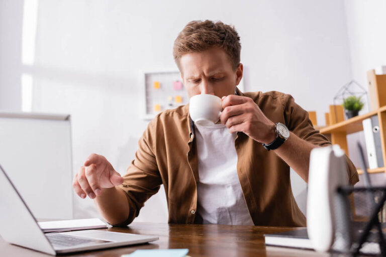 a businessman drinking coffee on his office