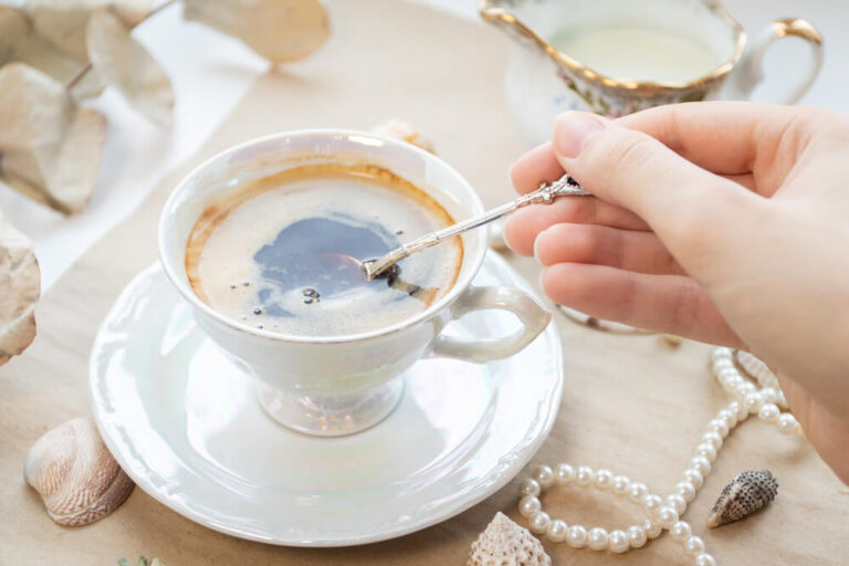 a woman stirring her cup of coffee