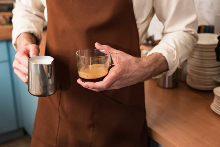 a man holding a cup of coffee and a milk