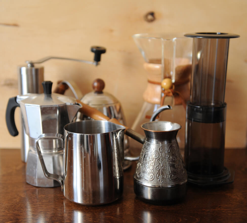 coffee makers on the top of a wooden table
