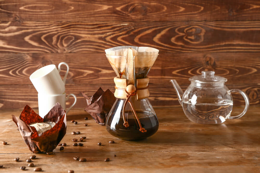 Tasty coffee in chemex on wooden table