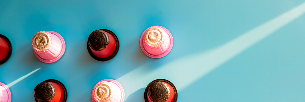 variety of italian coffee capsules placed on a blue surface 