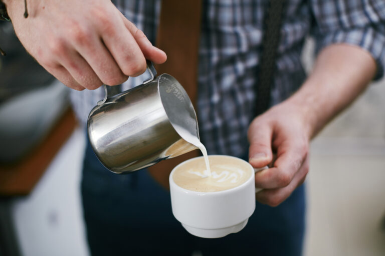 Milk frothed poured in a cup of coffee