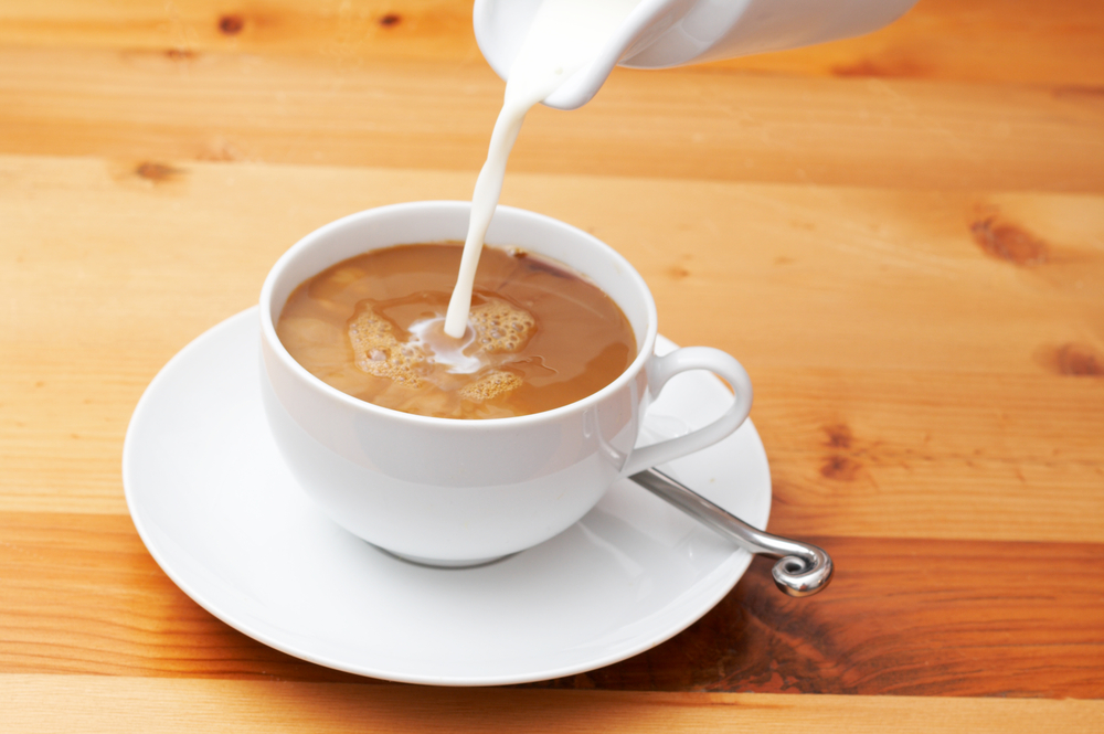 whole milk being poured down in a coffee