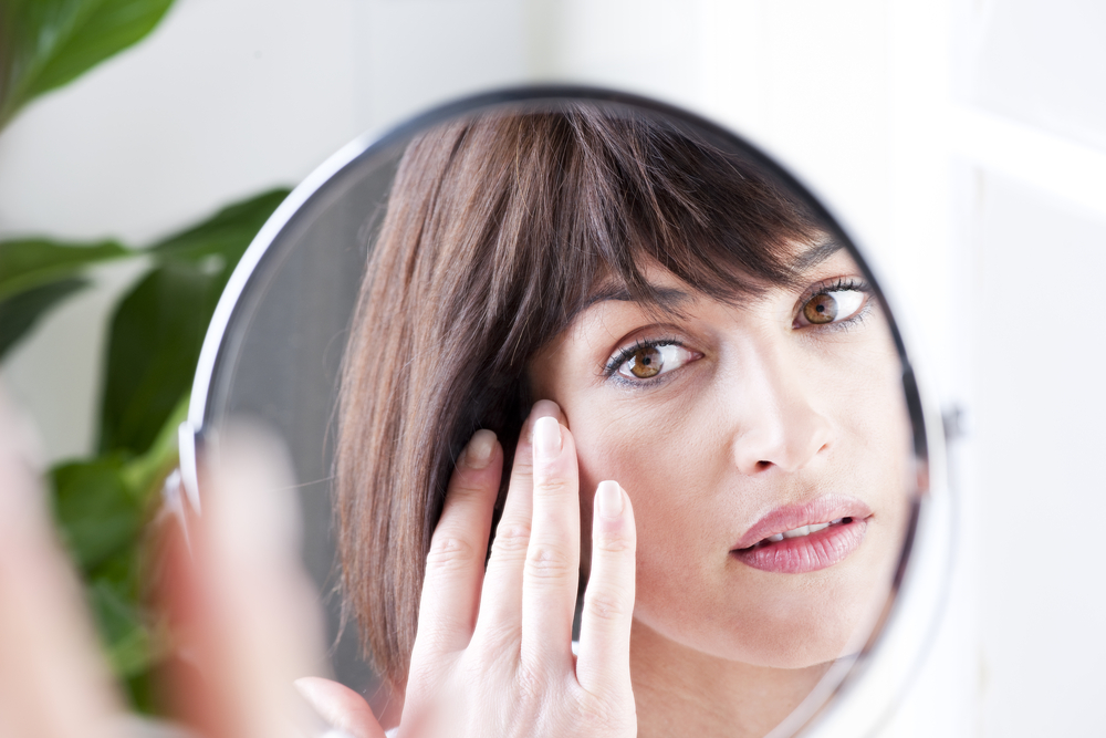 Woman Looking At Herself In The Mirror
