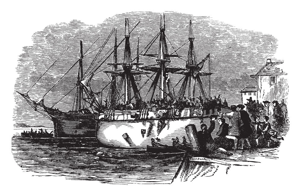 People destroying many crates of tea belonging to the British East India Company as a sign of protest against British Goverment