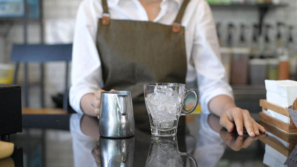 Woman making tea at a bar