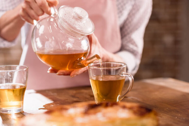 unidentified woman pouring tea - what is iaso tea