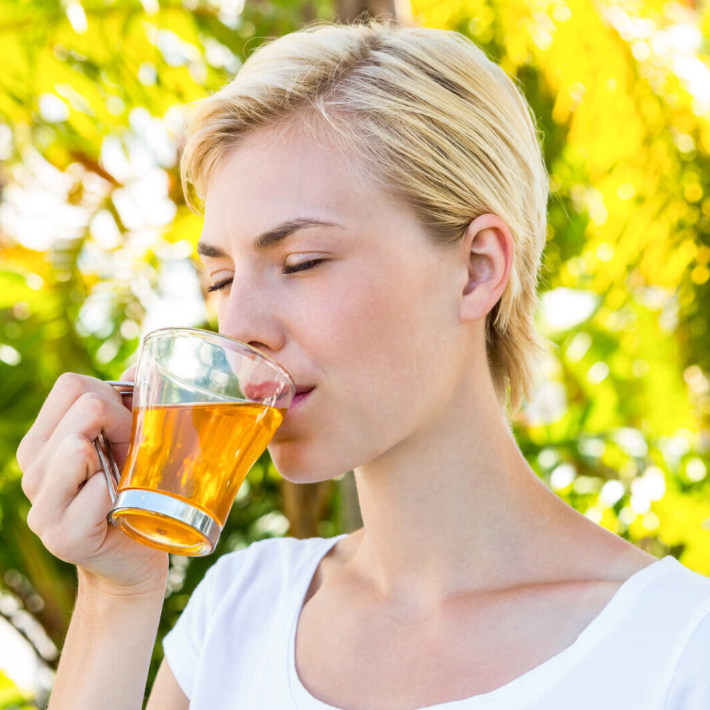 a beautiful woman drinking tea