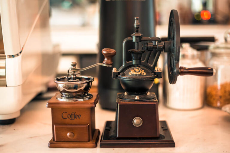 different types of coffee grinders on a wooden table - best coffee grinders for percolator