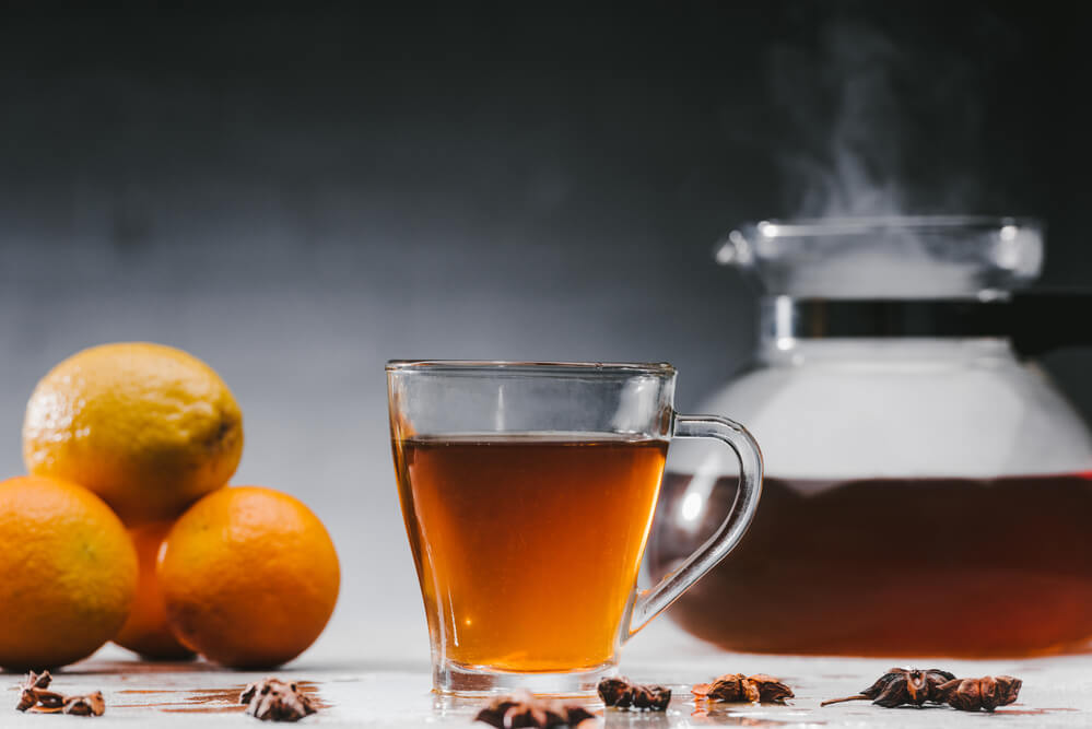 Cup of hot black tea with citrus fruits - is black tea hydrating