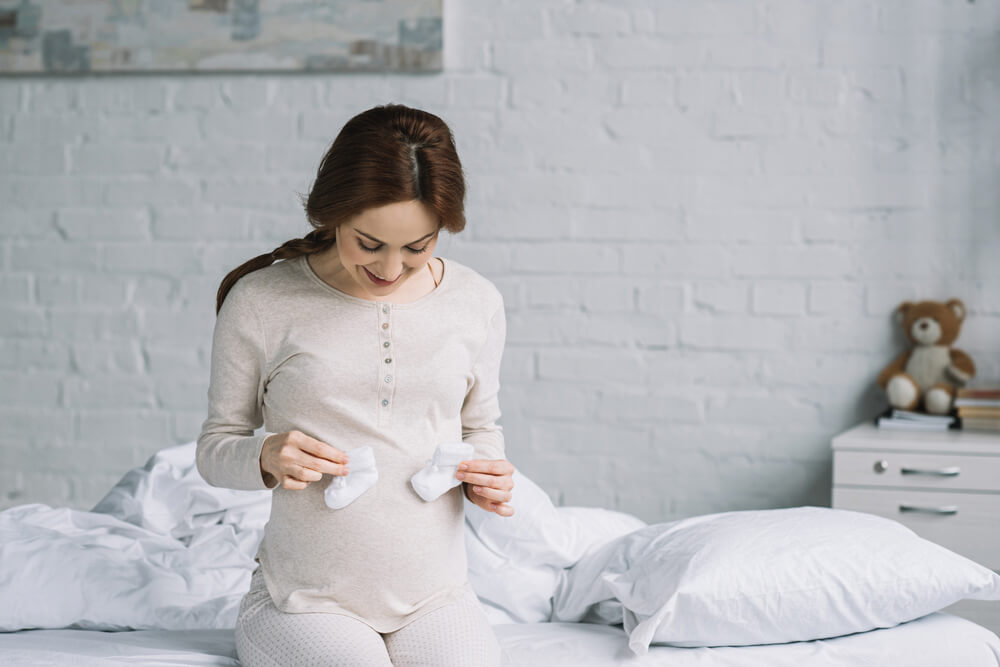 a beautiful pregnant woman touching her belly