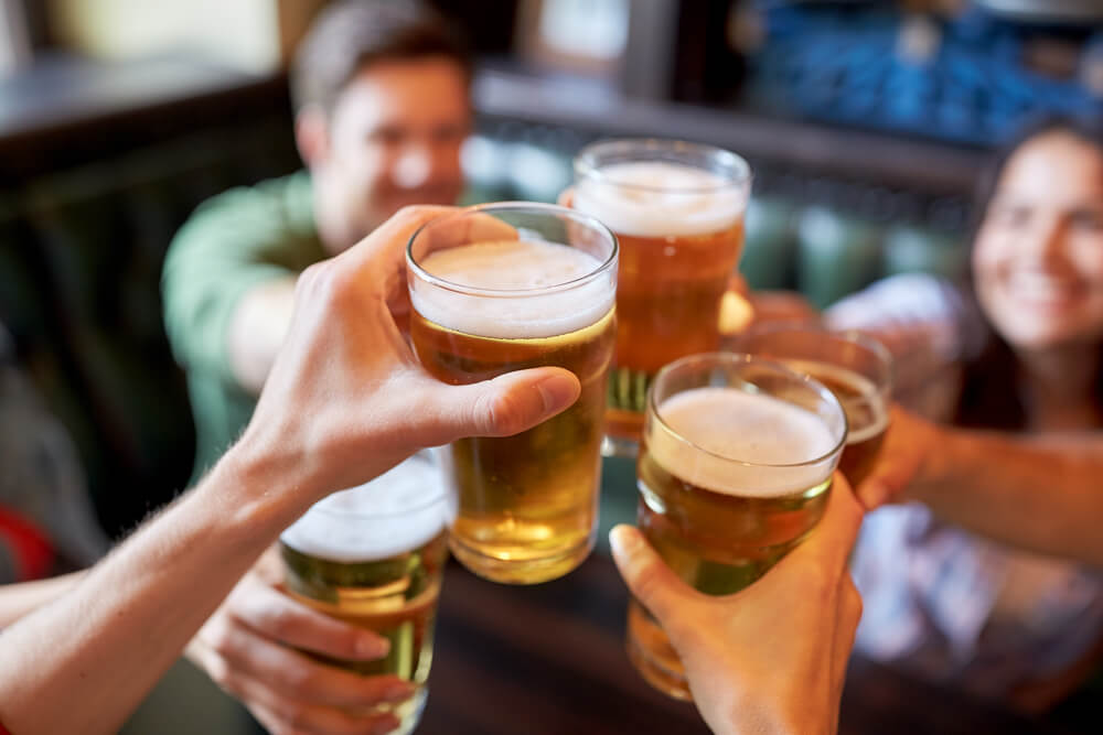 happy friends having a cheers holding beer
