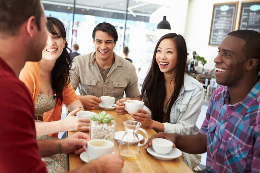 group of friends smiling inside a tea shop