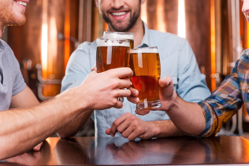 young men having a toast in a pub