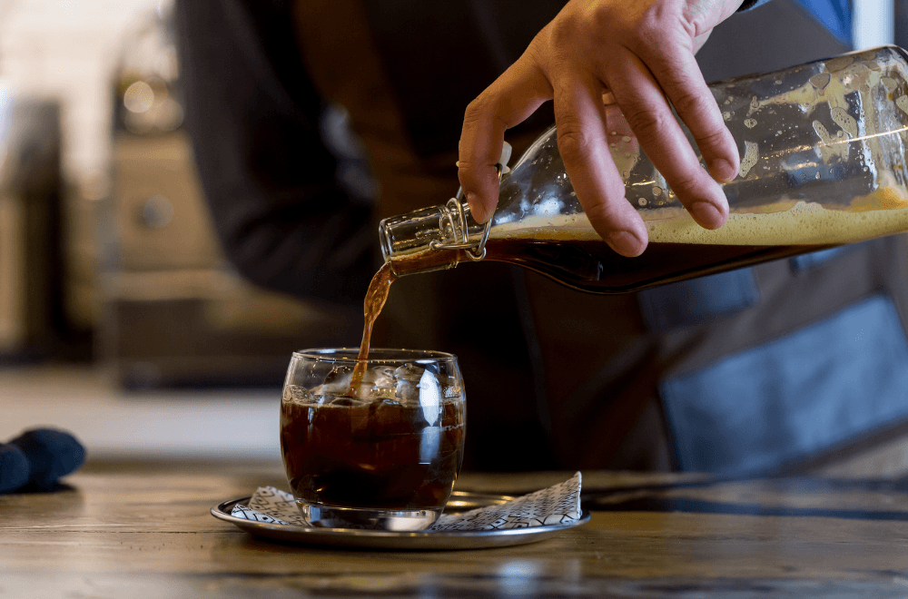 Cold brew coffee pouring over ice