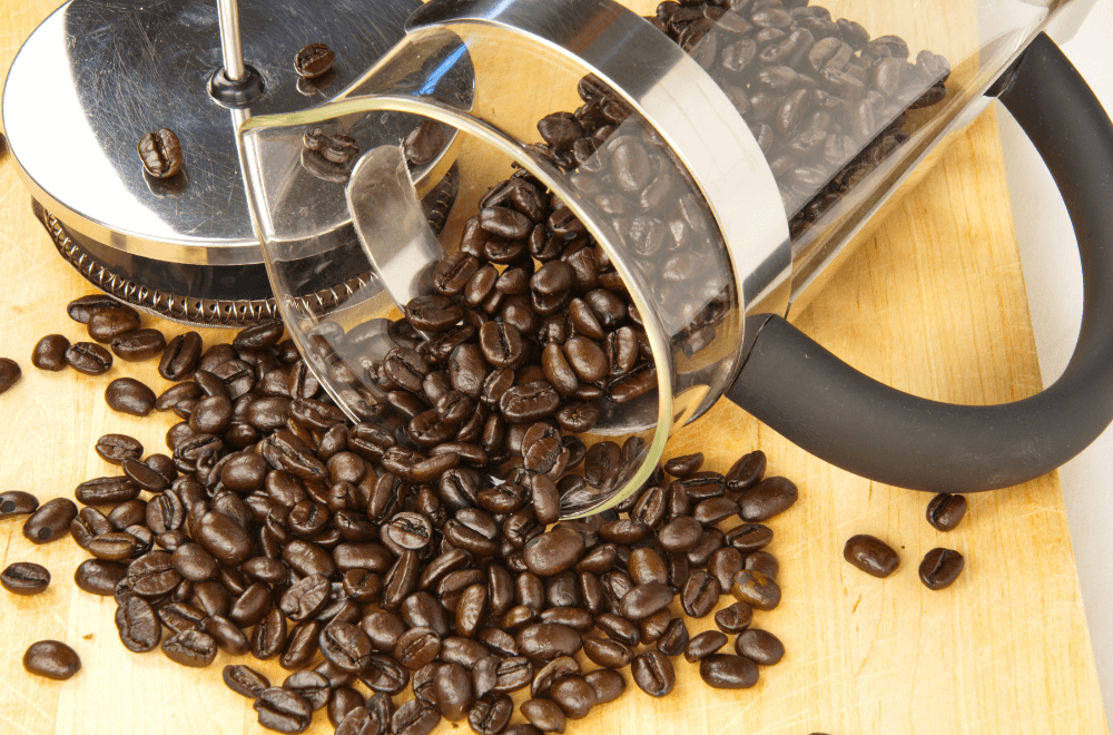 Coffee beans spill from french press