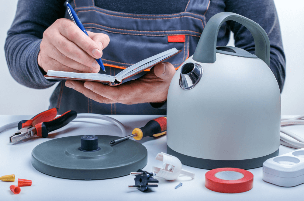 A man writing when he disassembles the electric kettle