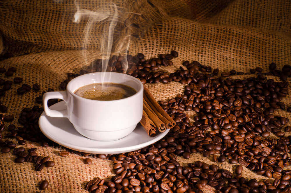 Coffee beans with a cup of coffee
