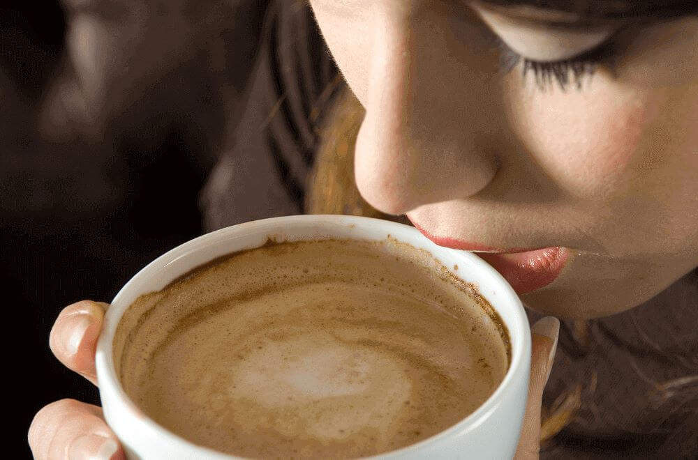 Woman drinking cappuccino