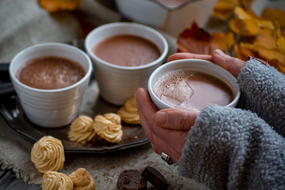 Tasty setup with cups and hot chocolate and autumn colors