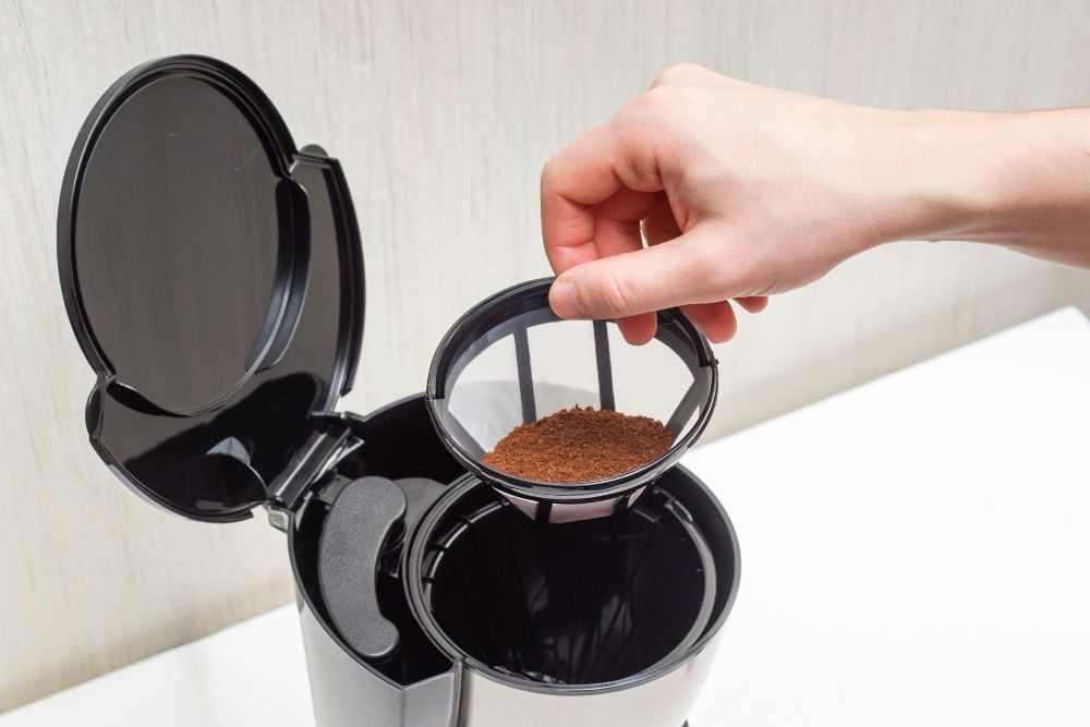 Brewing coffee from ground beans in a home coffee maker using a plastic filter