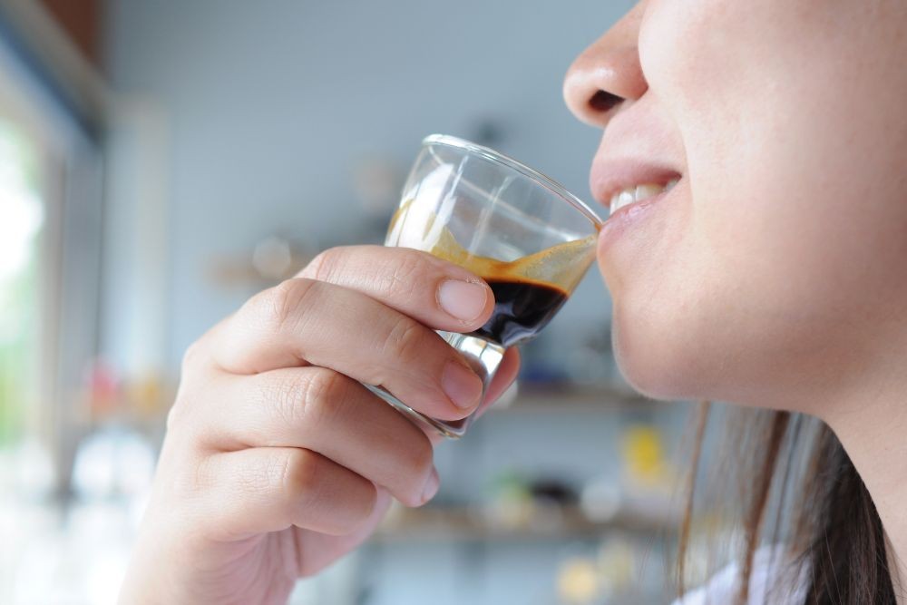Drinking a glass hot coffee ristretto