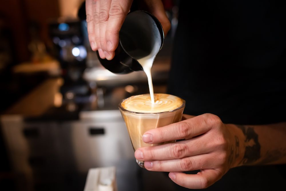 Making latte art on flat white coffee