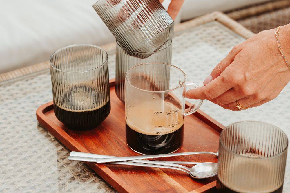 Glass coffee cups outdoors on table with lungo expresso measurement