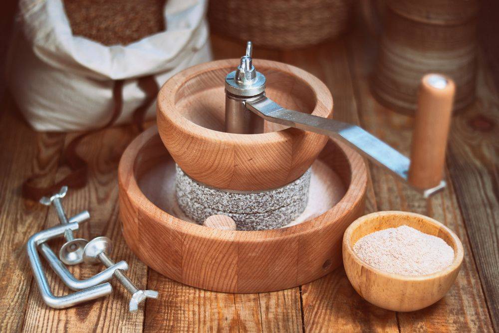 Grain grinder-Manual grain mill for hand grinding on a wooden table