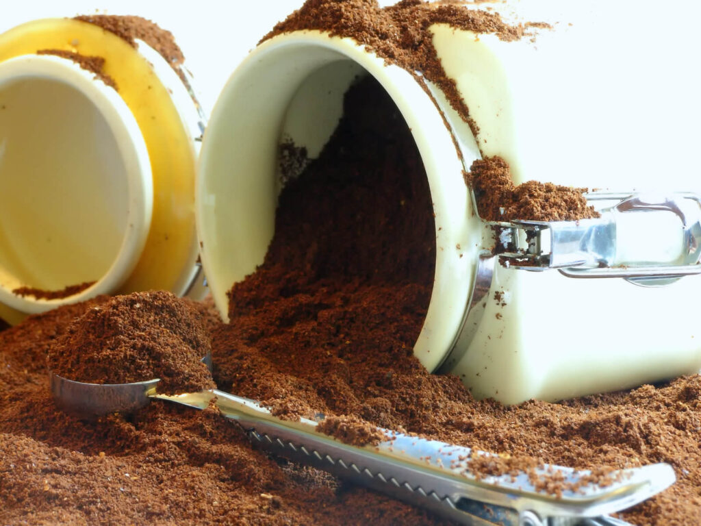 Spill ground coffee from white jar
