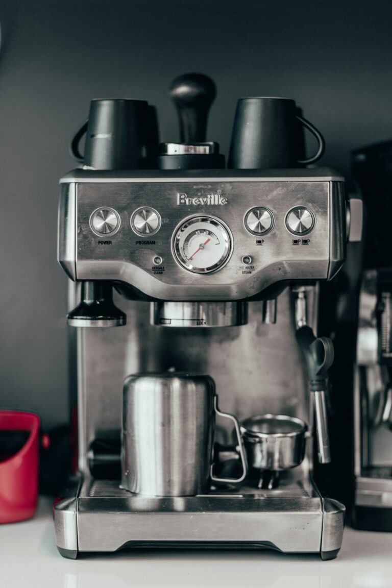 A real Breville espresso machine front panel with buttons, pressure gauge, and CLEAN/DESCALE indicator.