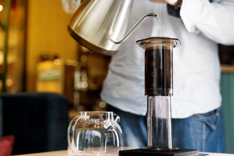barista making coffee using aeropress - difference between inverted and normal aeropress