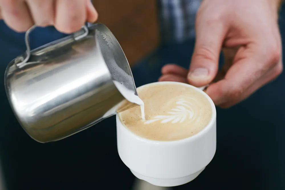 evaporated milk poured in a coffee