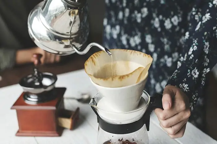 pouring hot water from a coffee kettle